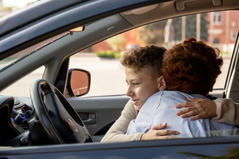 Teenage boy hugging his mother in a car representing improved emotional connection and calm using NeurOptimal®