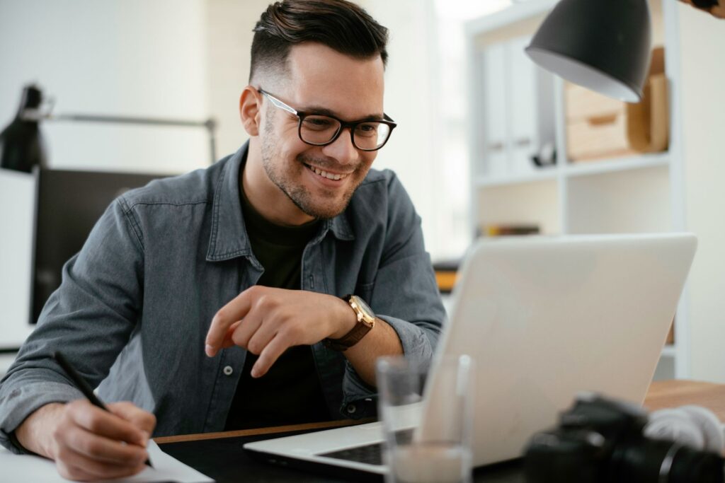 Man working on laptop at home representing a day trader using NeurOptimal® for stress reduction and focus