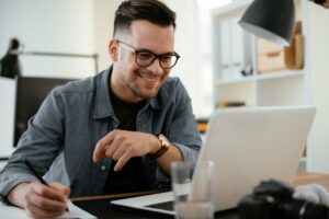 Man working on laptop at home representing a day trader using NeurOptimal® for stress reduction and focus