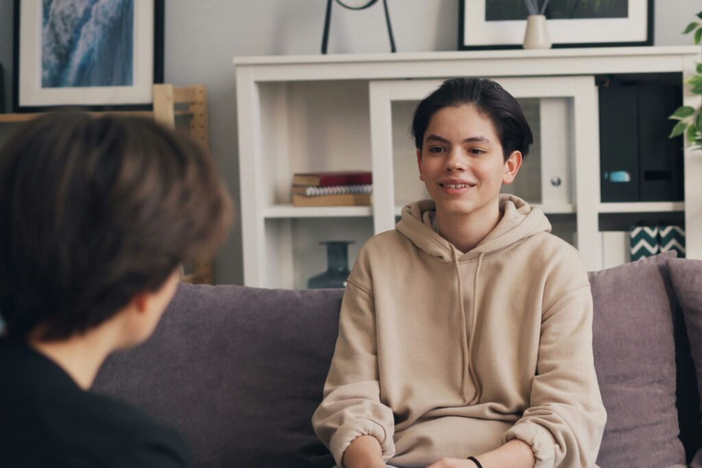 Young client sitting in a therapy session, representing progress and emotional shifts supported by Neurofeedback