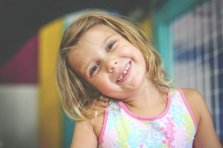 Young girl smiling confidently representing improved focus and learning with NeurOptimal®
