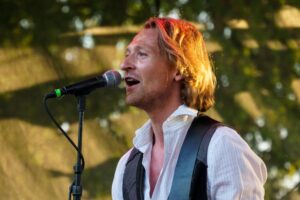 Musician performing on stage with confidence representing reduced stage fright using NeurOptimal®