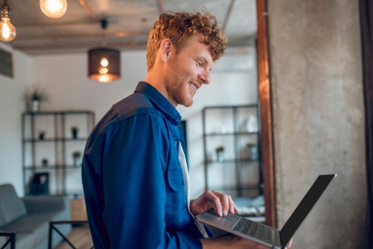 Man working on laptop at home representing improved clarity and emotional stability using NeurOptimal®