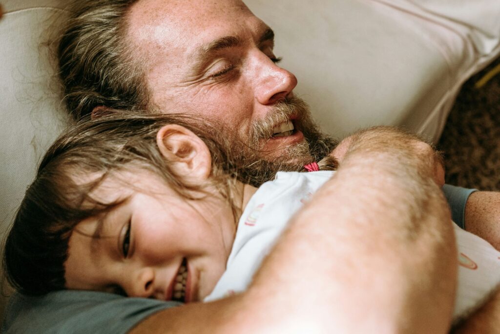 Father and young child sharing a calm and connected moment at home, representing improved focus and family bonding through Neurofeedback