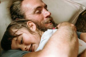 Father and young child sharing a calm and connected moment at home, representing improved focus and family bonding through Neurofeedback