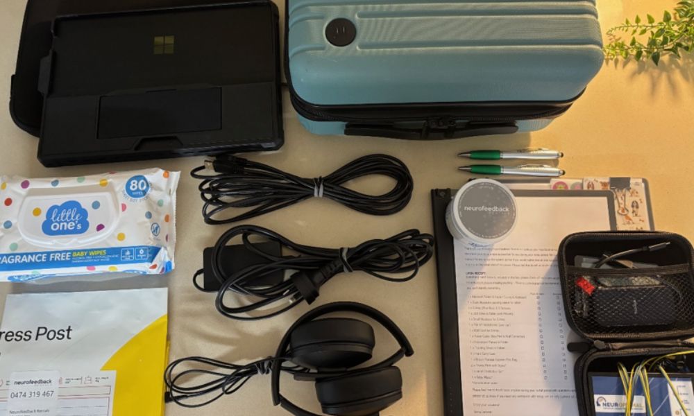 NeurOptimal neurofeedback home rental kit packed with laptop, headphones, sensors, cables and accessories