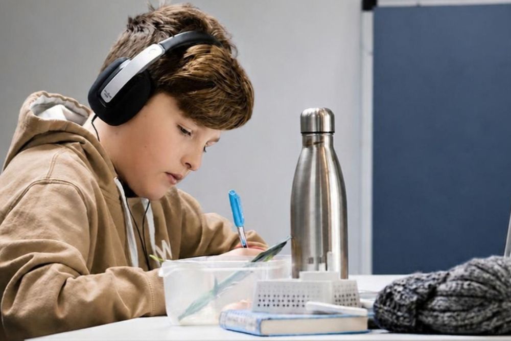 Child studying with headphones, representing ADHD focus and attention support with neurofeedback