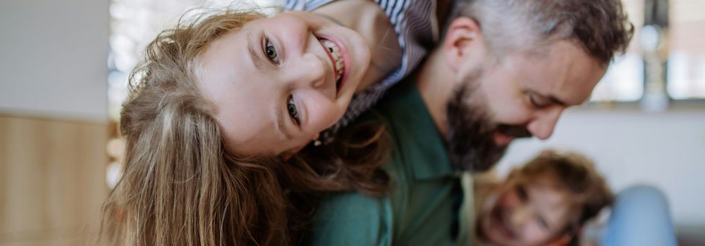 Happy family playing together at home, representing improved mood and positive family connection