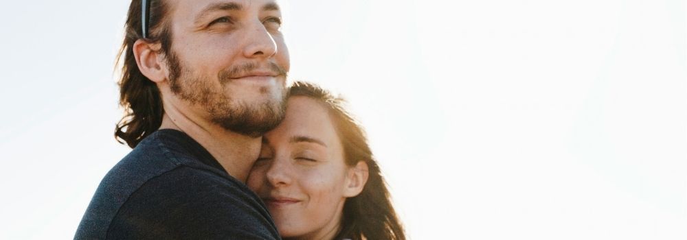 Couple embracing during their fertility journey, representing happiness, connection and emotional wellbeing