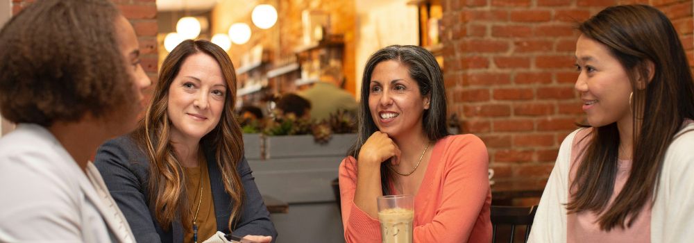 Group of women talking together, representing stronger communication, listening and social connection