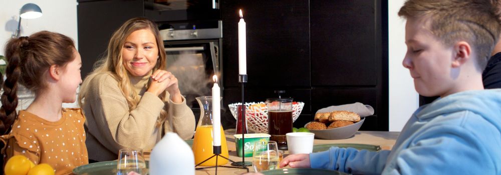 Family sharing a calm meal together at home, representing a calmer household for NDIS participants and their families