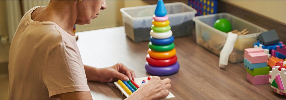 NDIS participant completing a hands-on activity, representing cognitive engagement, learning and brain health