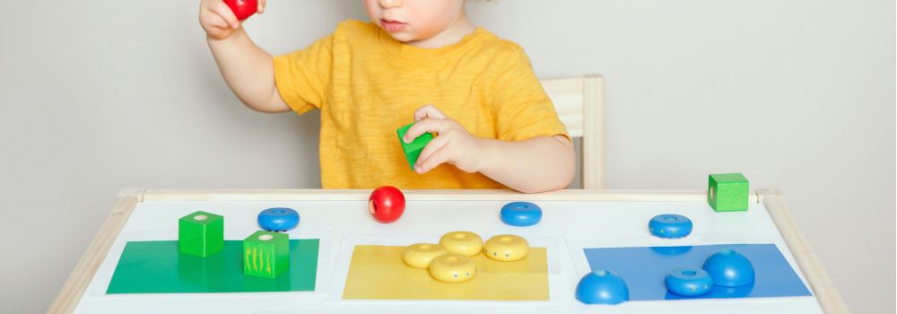 Child completing a learning activity, representing consistent progress towards developmental and NDIS goals