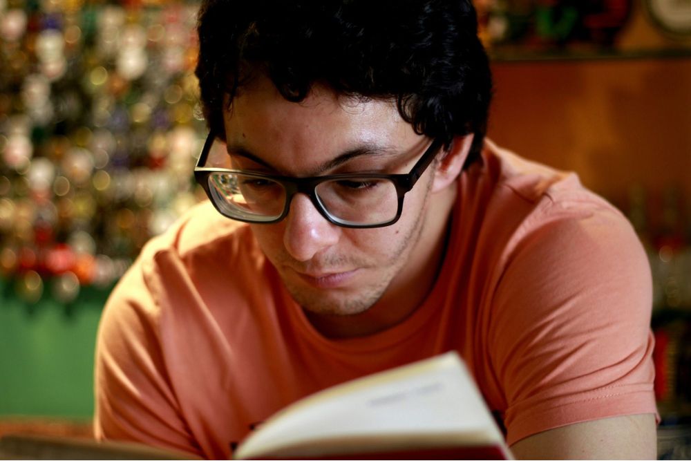 Man reading and concentrating, representing study, learning and focused attention