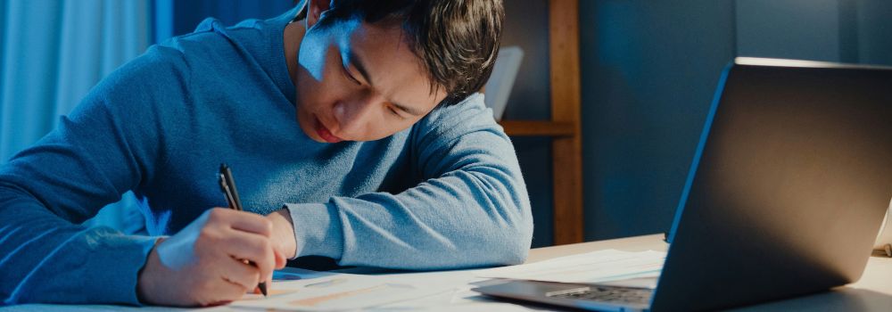 Student studying at a desk with a laptop, representing mental stamina for longer study sessions