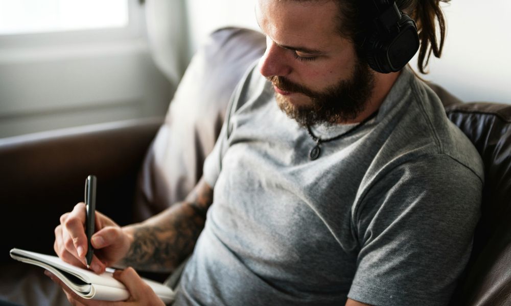 Man recording notes to track changes during a NeurOptimal neurofeedback program