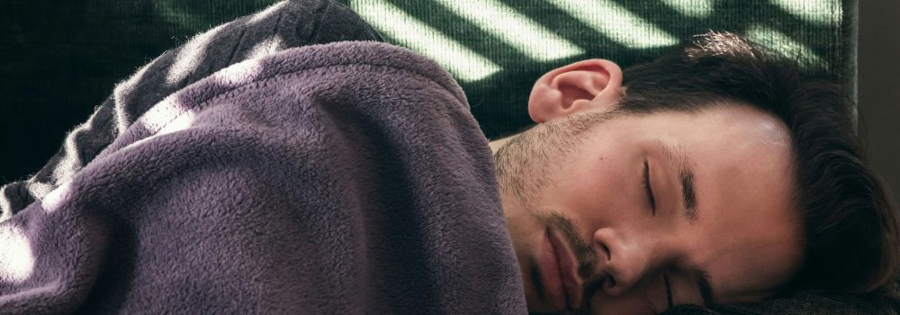 Man sleeping peacefully, representing better sleep and restorative rest after trauma