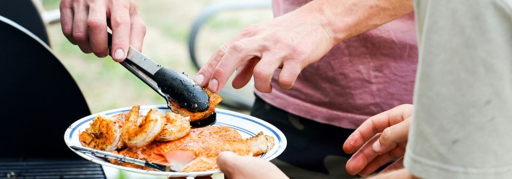 Veterans sharing a barbecue meal together, representing friendship, social connection and time with others