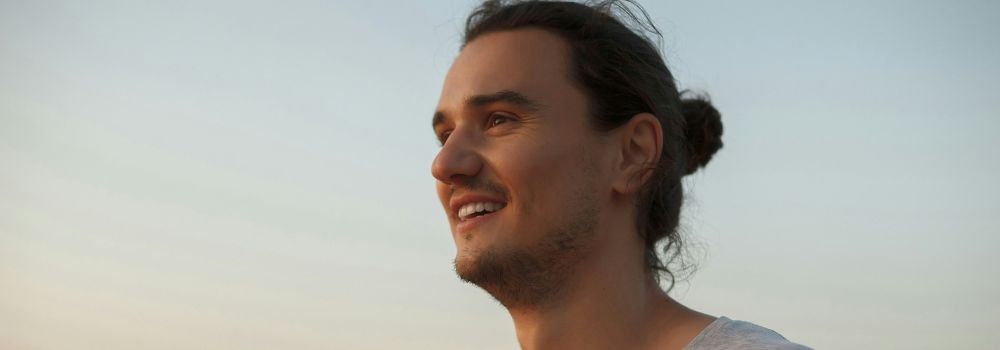Veteran smiling outdoors, representing inner calm, emotional wellbeing and feeling more comfortable within yourself