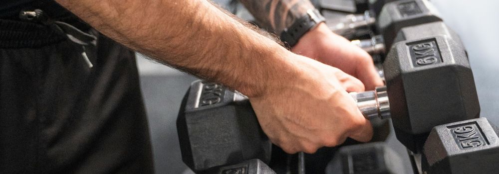 Veteran lifting weights at the gym, representing rebuilding strength, confidence and belief in yourself